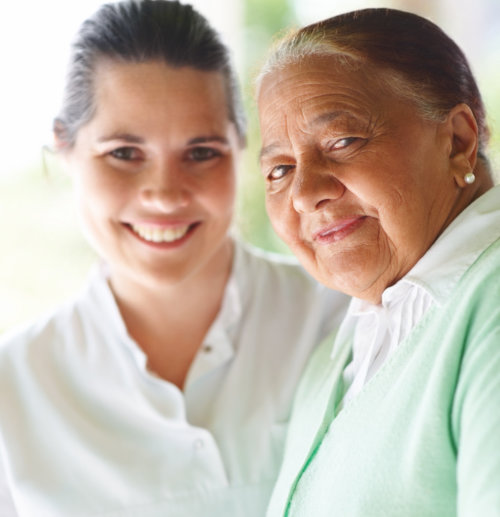 nurse assisting the elderly woman