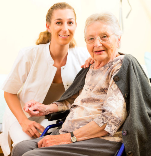 caregiver assists the woman in her room