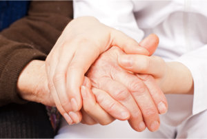 doctor holds the old woman's hands