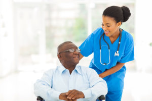 a nurse assisting the senior elderly man